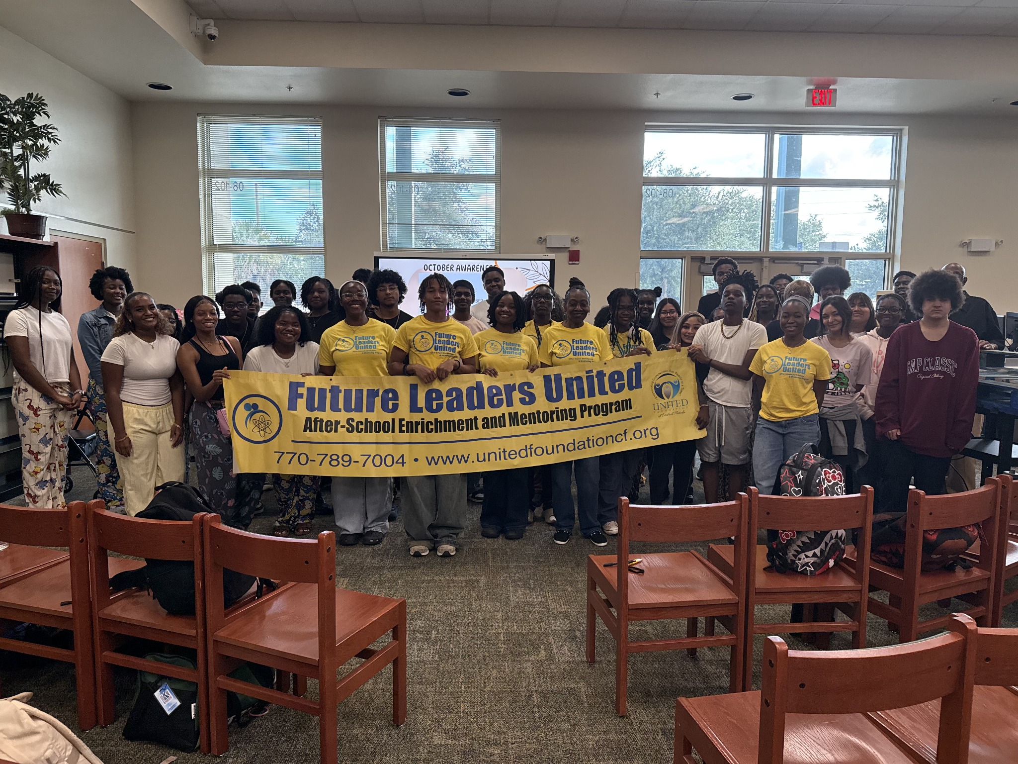 Students and team members with the Future Leaders United banner